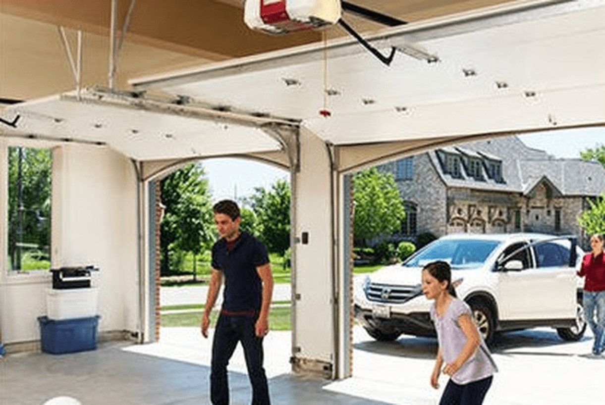 Two people in an open garage beside a raised garage door